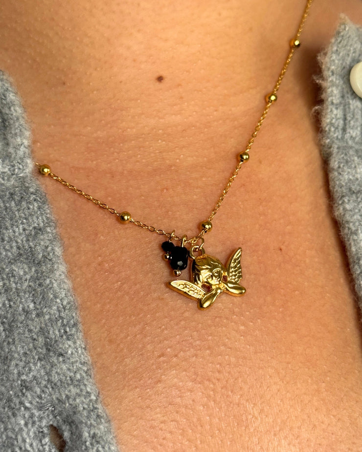 Soft, sweet, and full of meaning. The Angel Aura Ball Chain Necklace features a 16-inch 18k gold-filled ball chain with a delicate angel charm and two dainty black gemstone drops. Hypoallergenic, tarnish-free, and perfect for everyday layering, this piece brings a subtle celestial touch to your holiday looks.