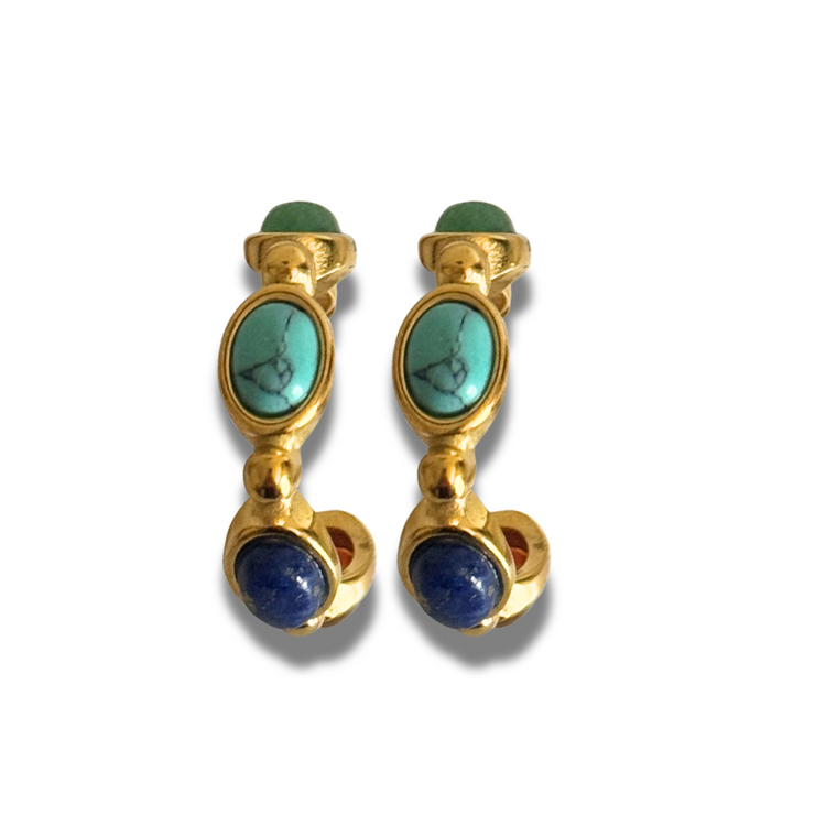 Pair of gold earrings with turquoise and blue stones on a white background