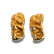 Pair of gold earrings on a white background . An organic, sculpted hoop that feels both natural and edgy. The hammered texture gives dimension without bulk, making it an easy everyday statement. 18k gold-filled, hypoallergenic, and tarnish-free.