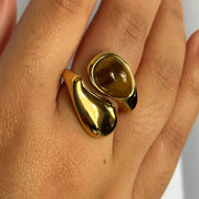 A stunning yin-yang inspired design. The Harmony Dual Gem Adjustable Ring features a beautiful contrast between a white synthetic pearl and a brown tortoise-style resin gemstone. Adjustable from sizes 7–9 and crafted with 18k gold-filled materials, this ring is waterproof, tarnish-free, and the perfect blend of balance and beauty.