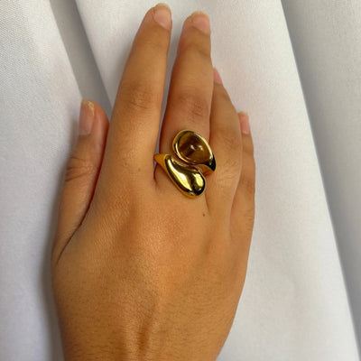 A stunning yin-yang inspired design. The Harmony Dual Gem Adjustable Ring features a beautiful contrast between a white synthetic pearl and a brown tortoise-style resin gemstone. Adjustable from sizes 7–9 and crafted with 18k gold-filled materials, this ring is waterproof, tarnish-free, and the perfect blend of balance and beauty.