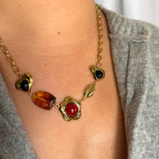 18k gold-filled 18-inch statement charm necklace with brown gemstone heart, gemstone flower, brown stone, and gold leaf charm