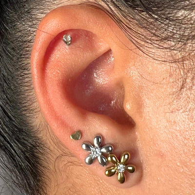 Sweet, simple, and effortlessly elegant — the Bloom CZ Stud features a delicate flower shape with a shimmering CZ center. Available in silver or gold, it’s the kind of earring you never want to take off.