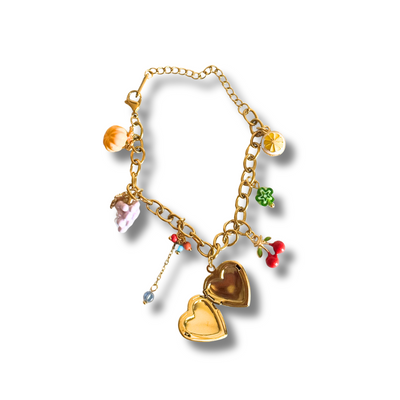 Gold bracelet with heart-shaped charms on a white background.“Colorful fruit charm bracelet with heart locket, lemon, grapes, pumpkin, cherry and tassel – 18K gold filled”
“Summer charm bracelet featuring dainty fruit and floral charms with multicolor beads – hypoallergenic”