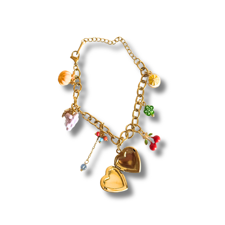 Gold bracelet with heart-shaped charms on a white background.“Colorful fruit charm bracelet with heart locket, lemon, grapes, pumpkin, cherry and tassel – 18K gold filled”
“Summer charm bracelet featuring dainty fruit and floral charms with multicolor beads – hypoallergenic”
