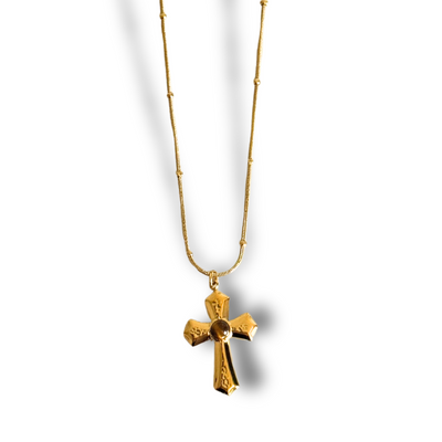Gold cross necklace on a white background. Gold-filled cross necklace with Tiger’s Eye center on a ball snake chain, worn at 16 inches; delicate, hypoallergenic, tarnish-free.
