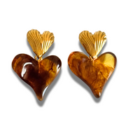 Heart-shaped earrings with gold tops and brown bottoms on a white background. Double heart stud: textured gold heart with amber resin heart drop; lightweight, hypoallergenic, tarnish-free.