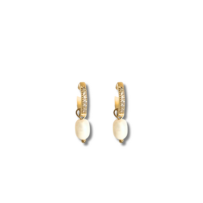 Gold crystal huggie earring with freshwater pearl drop, perfect for sensitive ears.Crafted in 18K gold-filled material, this earring is hypoallergenic, tarnish-free, and perfect for sensitive skin. A lightweight everyday luxury that adds a touch of ocean elegance to any outfit.
