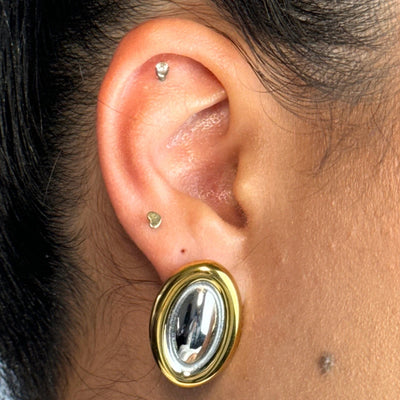 With a sleek gold outline and a silver inner glow, the Nova Oval Stud brings that trending energy in the most timeless way. It’s minimal, sculptural, and a total must for your ear stack rotation.
