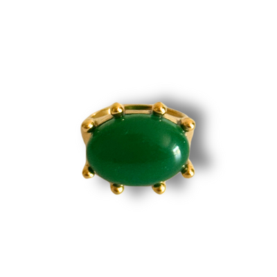 Green gemstone in a gold setting on a white background.Green gemstone statement ring in 18k gold-filled finish; size 7 only; tarnish-free and waterproof for daily wear