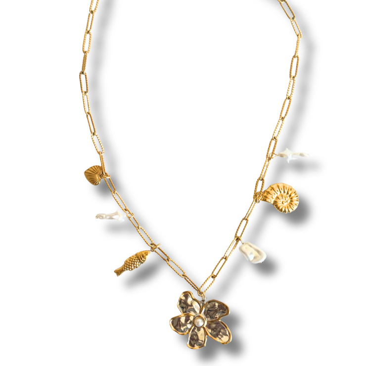 Gold necklace with floral pendants on a white background. Tarnish-free and hypoallergenic, it’s made for sensitive skin and everyday wear.

mixed metal charm necklace, floral pearl necklace, coastal necklace, seashell charm necklace, beach jewelry

Mixed Metal Flower and Pearl Charm Necklace

Coastal Bloom Gold and Silver Necklace

Mixed metal necklace with floral centerpiece, faux pearls, heart, and seashell charms

Gold and silver charm necklace