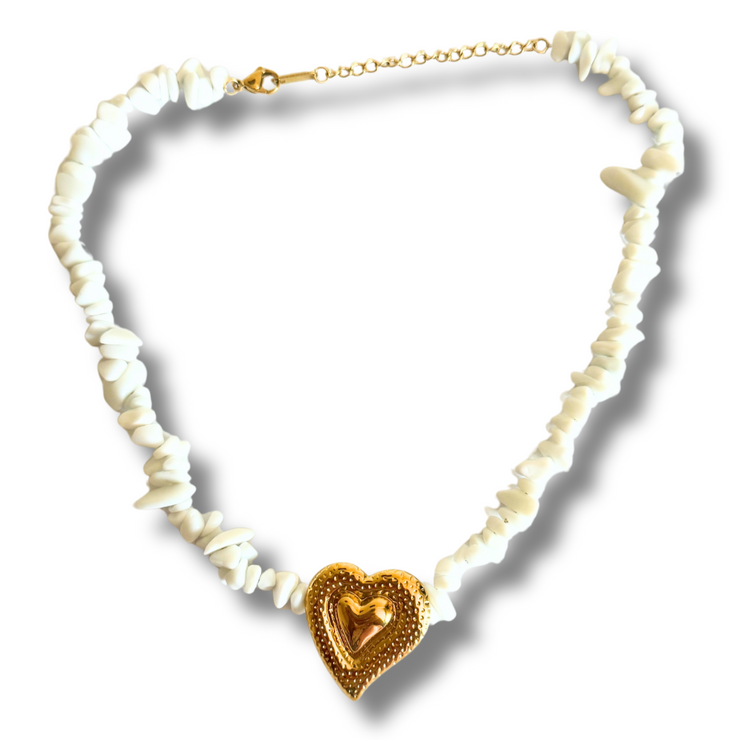 Necklace with heart-shaped gold pendant on a white background.natural stone heart necklace, beach stone jewelry, white stone necklace, textured heart pendant, romantic summer jewelry
Image Title Options:

Waves of Love White Stone and Heart Necklace

Natural Beachy Necklace with Textured Heart Pendant
Alt Text Options:

Natural white stone necklace with gold wavy heart charm

Beach-inspired necklace with organic stones and romantic heart centerpiece 