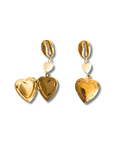 These 18K gold-filled earrings are hypoallergenic and tarnish-free – the perfect summer statement for romantic souls and beach lovers alike.
Gold dangle earring with seashell charm, pearl heart, and heart locket, ocean-inspired