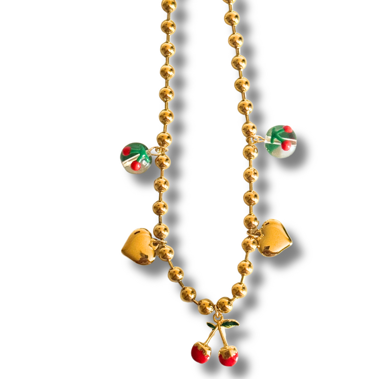 Gold necklace with heart and cherry pendants on a white background. cherry charm necklace, fruity gold necklace, playful heart charm necklace, sweet summer jewelry

Cherry Sweetheart Charm Necklace

Fruit-Inspired Cherry and Heart Necklace
Gold charm necklace with large cherry, heart, and glass cherry charms
Playful cherry charm necklace with red and gold details