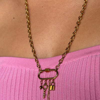 24-inch charm necklace with a vintage key, lock, iridescent bead, and dainty chain. Hypoallergenic, tarnish-free, waterproof, and perfect for layering or statement wear.