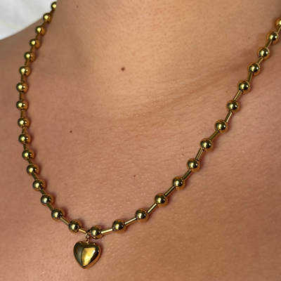 Bold ball and line bead necklace with a central bubble heart charm, symbolizing the strength and resilience of love. Hypoallergenic, tarnish-free, and perfect for making a statement.