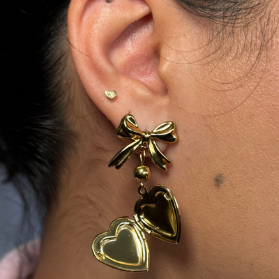 Elegant bow and heart locket earring that holds a small photo, hypoallergenic and tarnish-free, perfect for sentimental keepsakes.